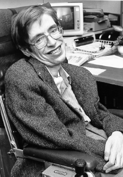 Stephen Hawkings sitting at his desk.